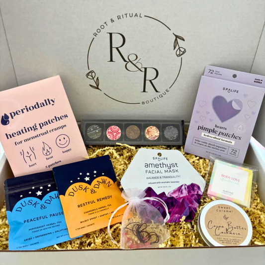 feminine self care gift box for menstrual cycle relief, period cramp relief, feminine energy. Featuring heating patches, pimple patches, Korean skincare face mask, K-beauty facial, affirmation cards, candle, tea blends, chocolate truffles, and crystal energy bracelet